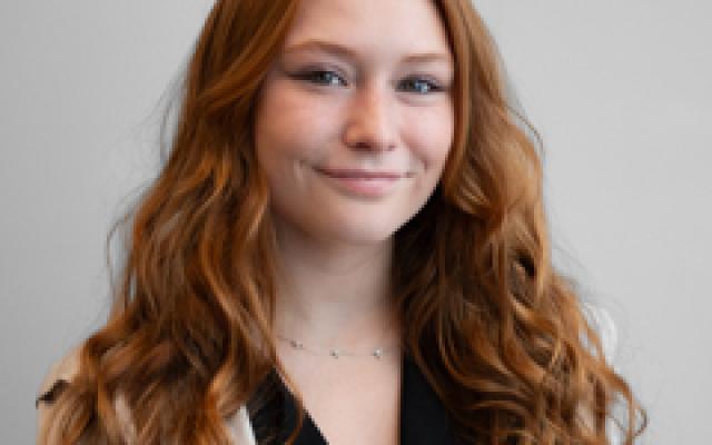 Picture of a girl with long red hair smiling