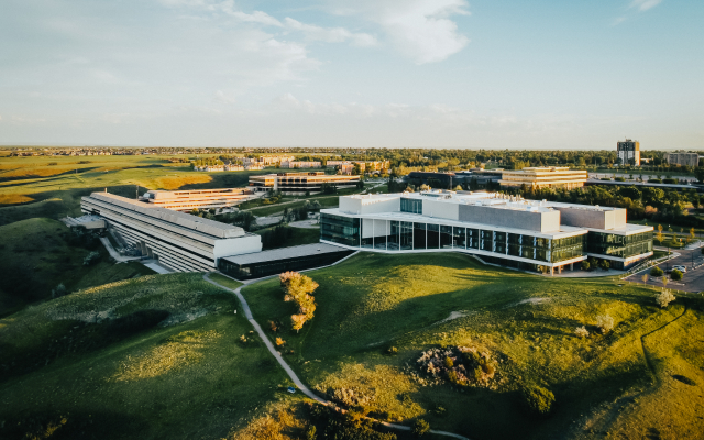 Overhead drone shot of the University of Lethbridge campus during the summer time. Picture primarily showcases the science and UHall buildings