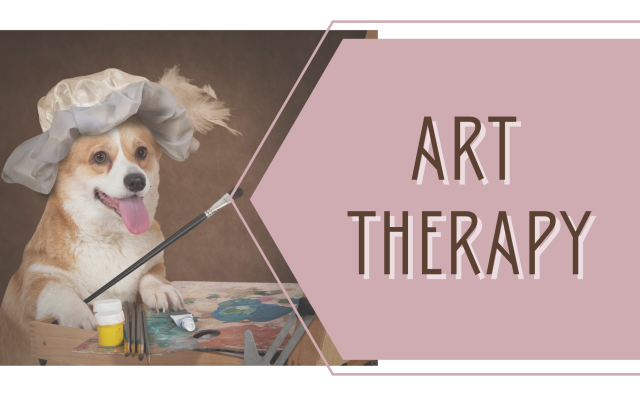 Art Therapy workshop banner. A corgi wearing a brimmed hat, sitting upright like a human, holds a paintbrush in his paw which is resting on a table covered with art supplies. 