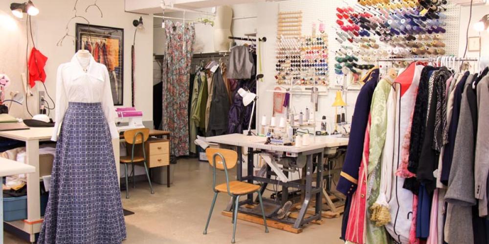 sewing station and rack of costumes