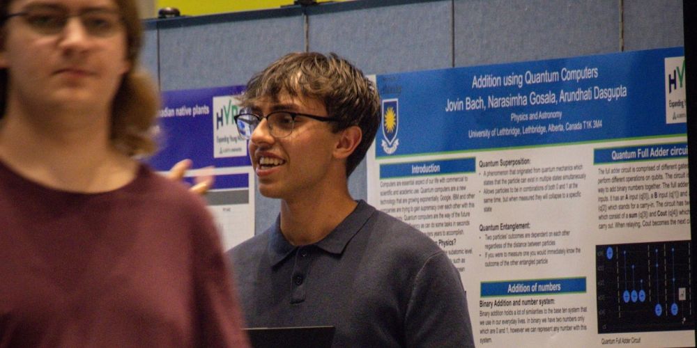 hyrs student smiling at their poster