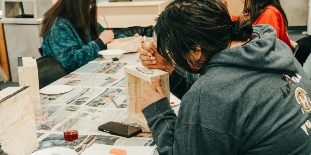 Photo of a student painting a smudge box