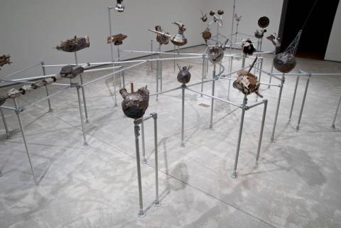 Sculptures mounted on metal piping